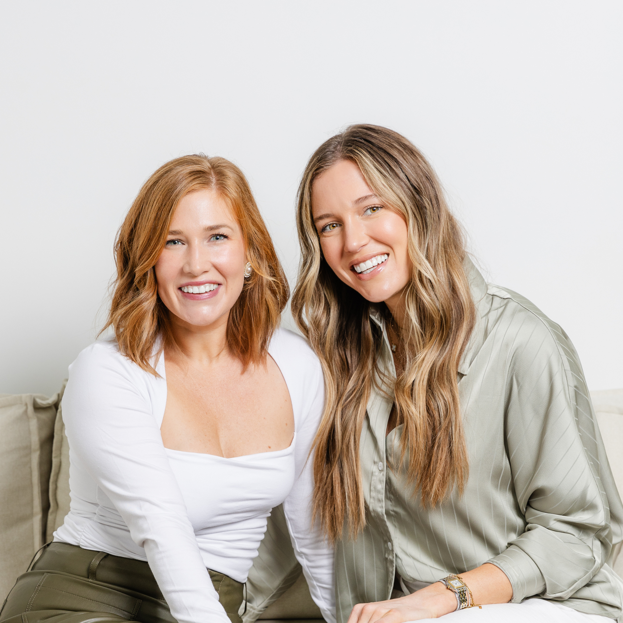 two women sitting on couch
