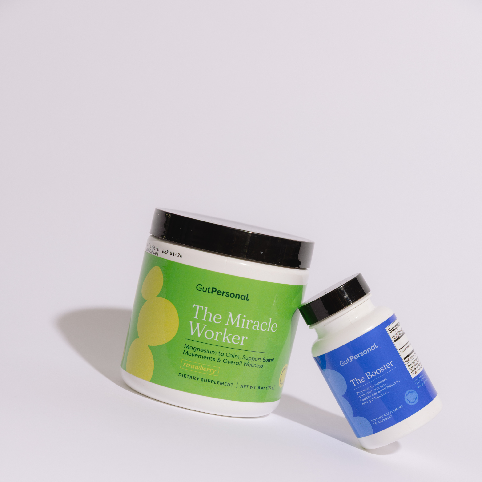 Two supplement containers labeled 'The Miracle Worker' and 'The Booster' on a white background