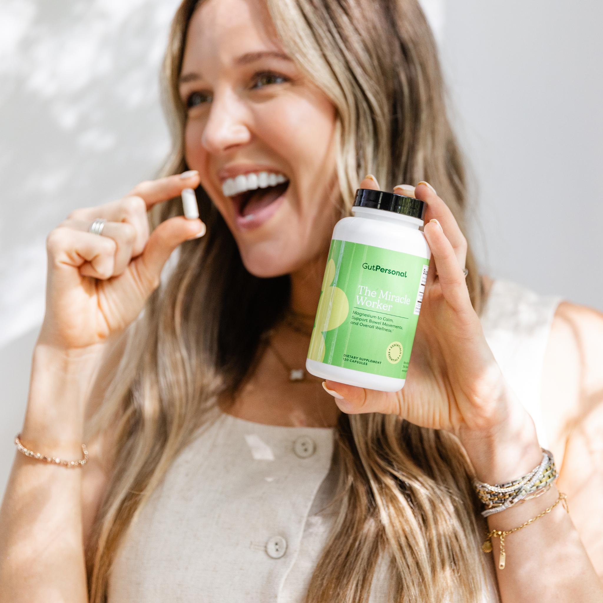 women holding magnesium capsules
