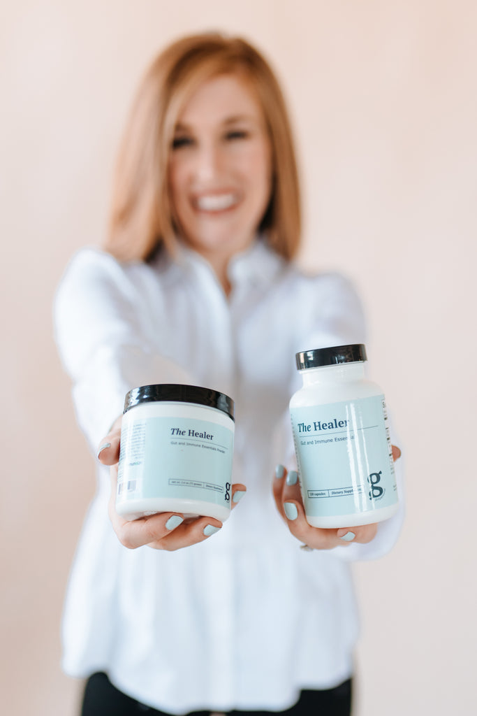Owner of GutPersonal, Bridgitte, holding the healer supplements.