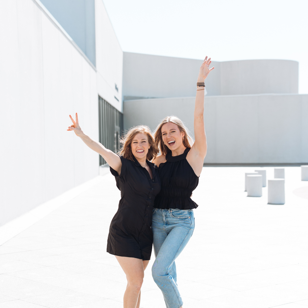 two women with their arms in the air