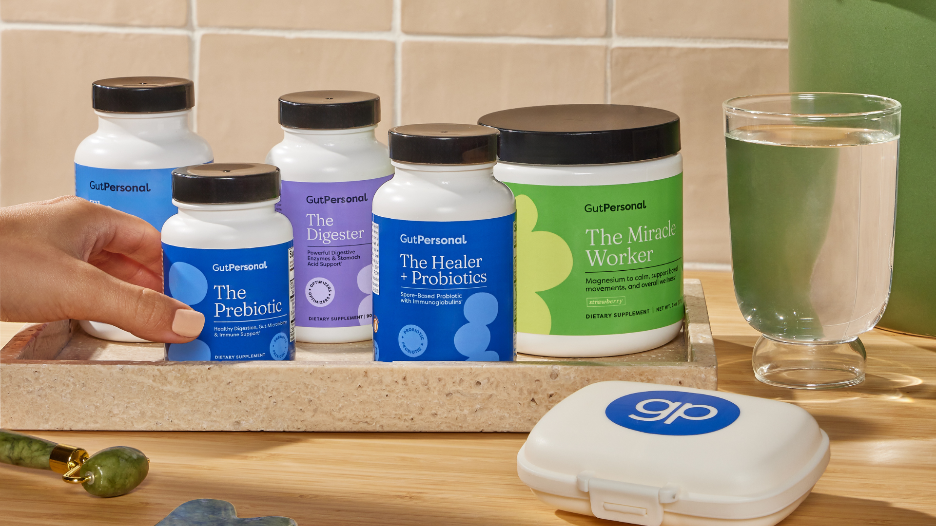 supplements by gutpersonal with a glass of water a pill container