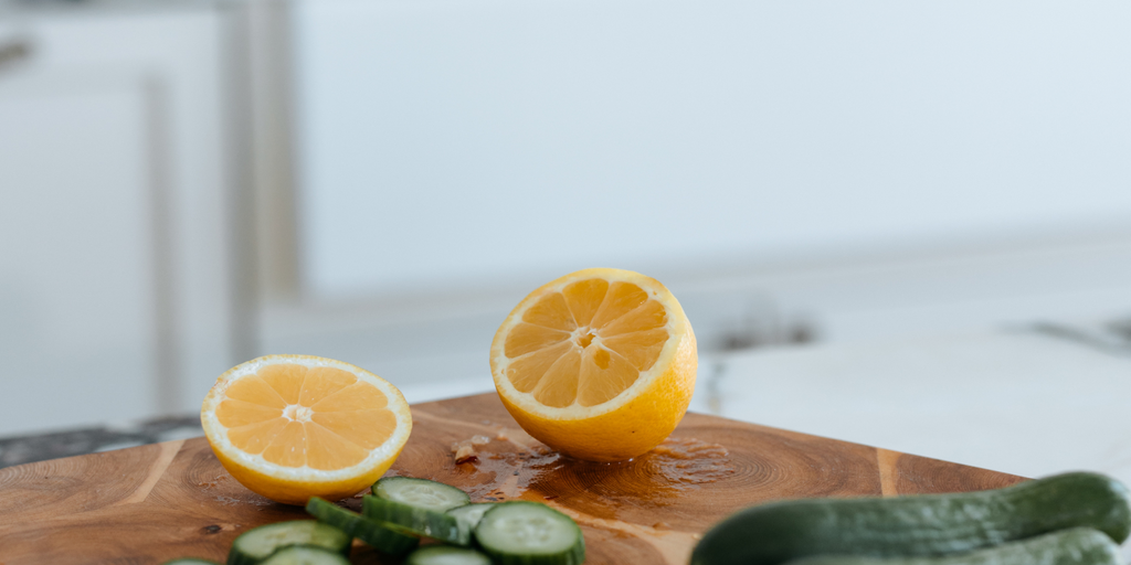 a photo fo lemon and cucumber on a cutting board